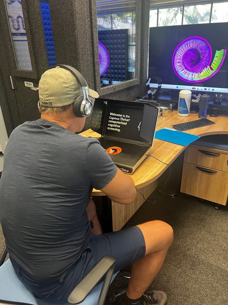 A guest at Serenity Hearing Centers completing a Cognivue Thrive computerized cognitive screening in-office